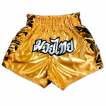 Custom gold muay thai shorts in shiny satin with Thai script embroidery and black side tribal panels