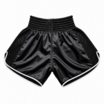 Black mesh panel muay thai shorts in custom satin with white piping and elastic waistband